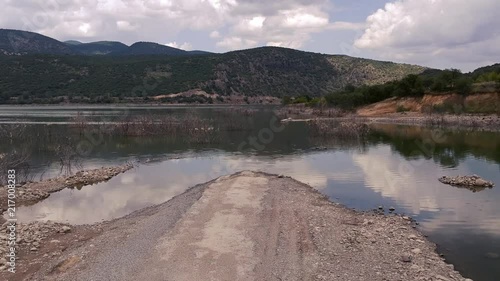 Old asphalt road submerged under the waters of Doğanözü dam in Kızılcahamam. Ankara in Turkey