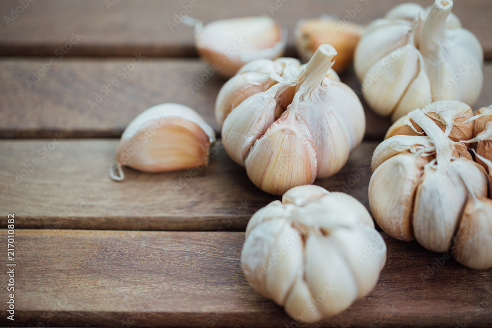 Garlic and cloves on wooden background Garlic and cloves on wooden background