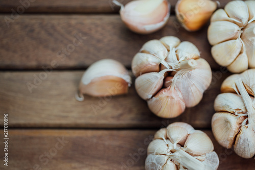 Garlic and cloves on wooden background