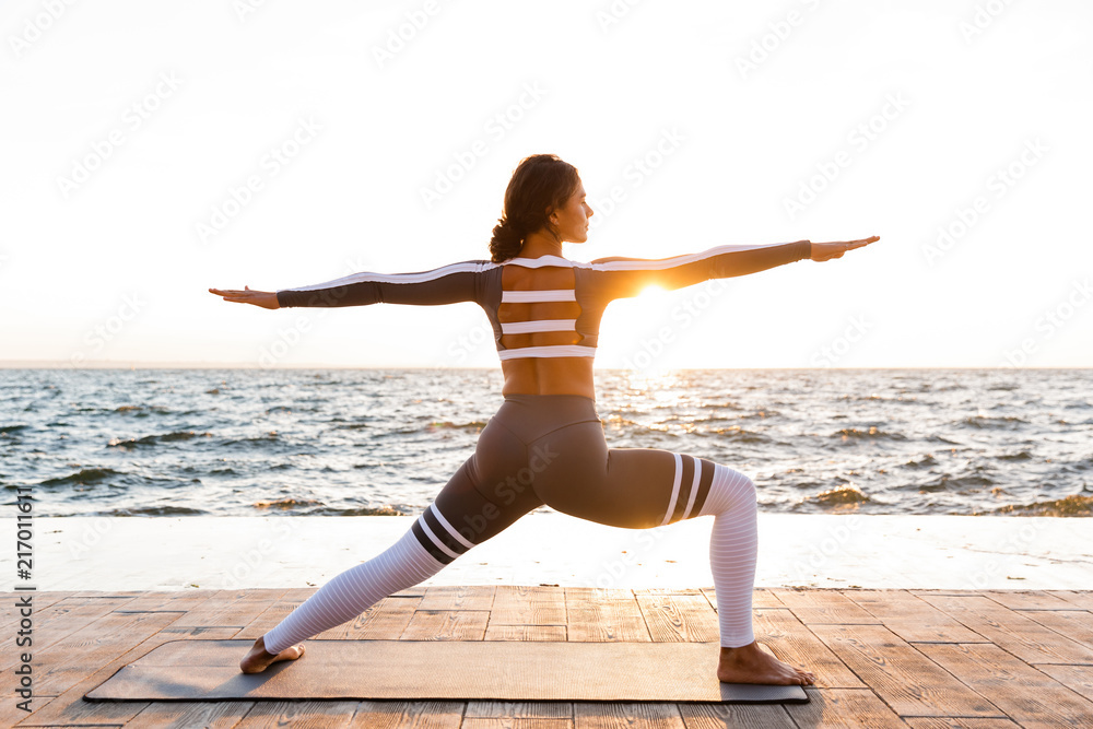 Strong young fitness woman stretching exercises. Strong young fitness woman stretching exercises.