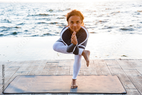 Young fitness lady stretching exercises.