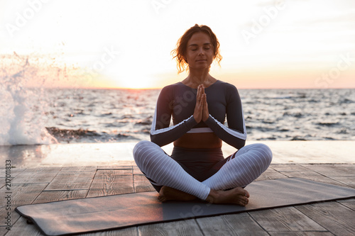 Strong young fitness woman meditate.