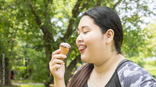 fat girl eat ice cream in close up face feeling delicious photo