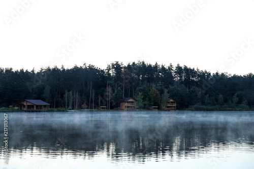 Beautiful landscape with forest and houses near lake. Camping season