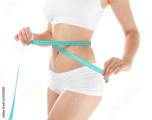 Beautiful young woman with measuring tape on white background. Healthy diet