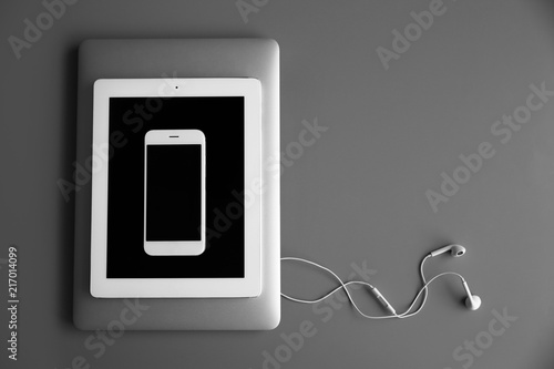 Devices with blank screens on grey background, top view. Mock up for design