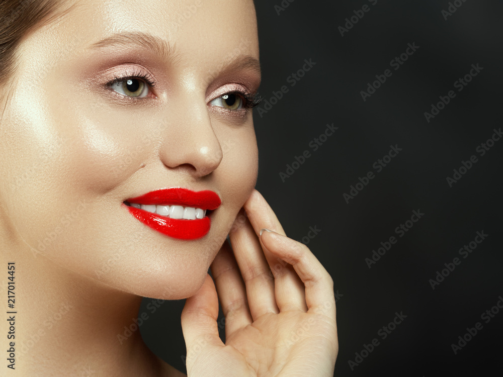 Fototapeta premium Makeup, cosmetics. Beauty young woman portrait. Beautiful model girl with beauty makeup, red lips, perfect fresh skin. Attractive lady with green eyes. Youth and Skin Care Concept