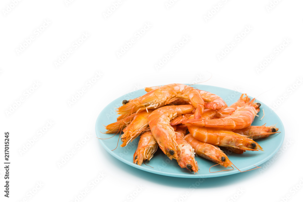 Grilled shrimps on blue plate isolated on white background. Copyspace Grilled shrimps on blue plate isolated on white background. Copyspace