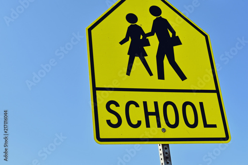 Yellow SCHOOL Signage against Blue Sky