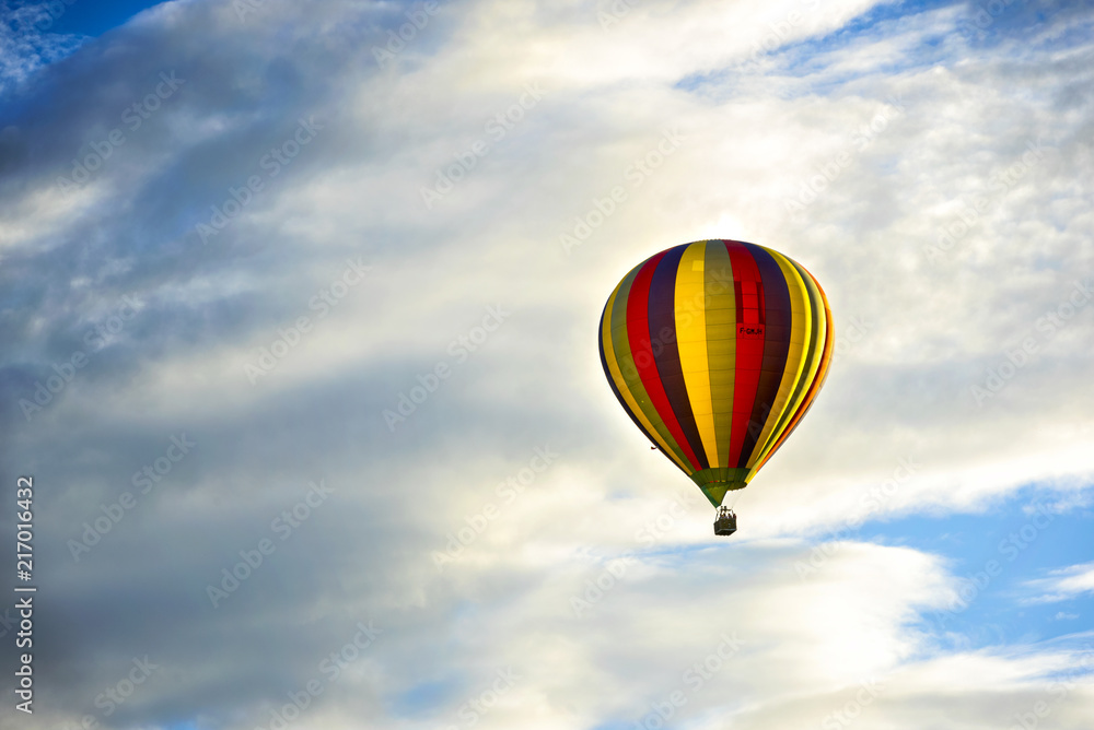 Beautiful Hot Air Balloon Against a Deep Blue Sky and Clouds. Beautiful Hot Air Balloon Against a Deep Blue Sky and Clouds.