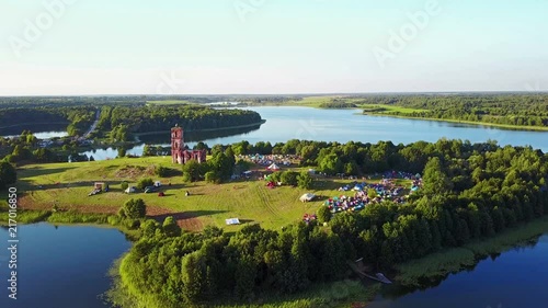 BELARUS, BELAYA CERKOV - August 04, 2018: International open air festival SPRAVA in Belarus. Aerial panoramic view with the ruins of the old church at sunset. 4K-video. photo