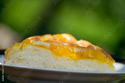 Delicious cake with apricot jam on a plate. Crostata with marmalade or peach jam filling. Homemadepie dessert with dandelion jam.