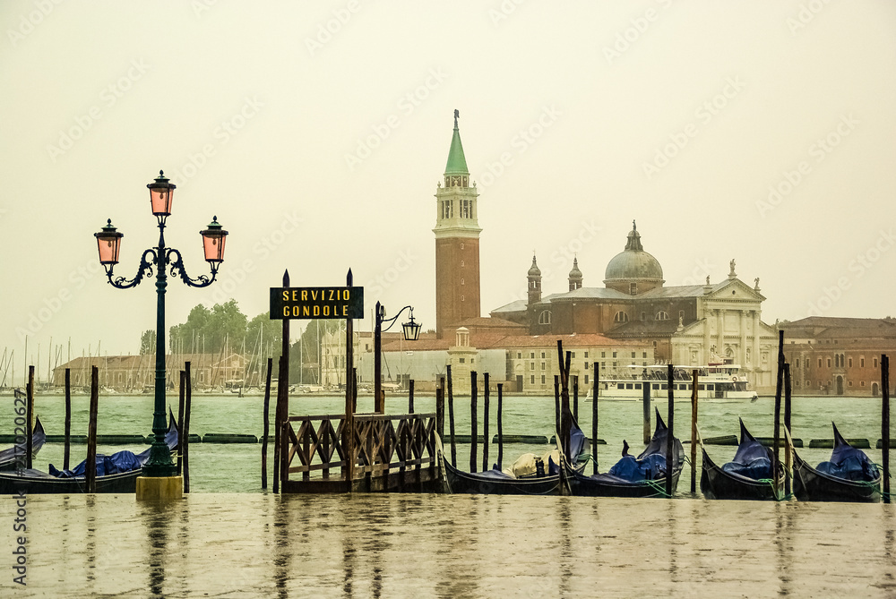 Rainy day on a gondola pier in Venice Italy