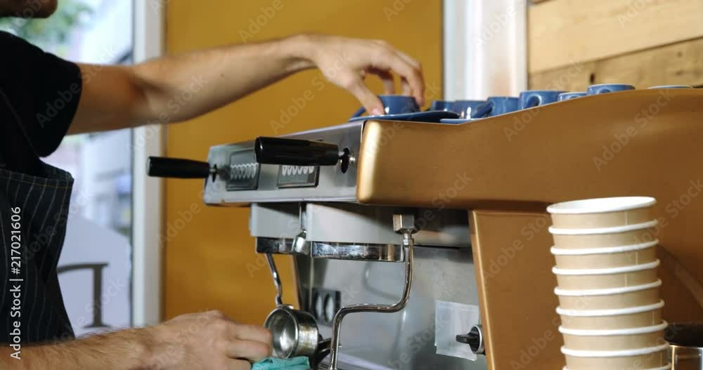 Male waiter cleaning coffeemaker machine 4k Male waiter cleaning coffeemaker machine 4k