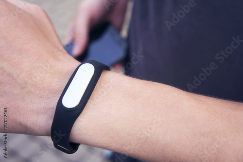 Fitness tracker on the man's hand, sports accessory fitness bracelet.