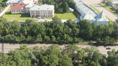 Flight of the camera over Saint Sophia orthodox cathedral and church of Resurrection of Jesus in a sunny summer day in Vologda Kremlin. photo