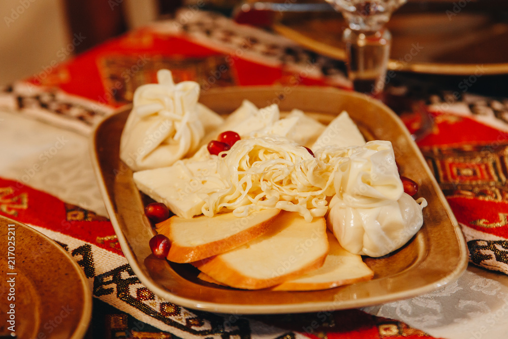 Caucasian Georgian cheese served on a plate on the day of national holiday. Caucasian Georgian cheese served on a plate on the day of national holiday.
