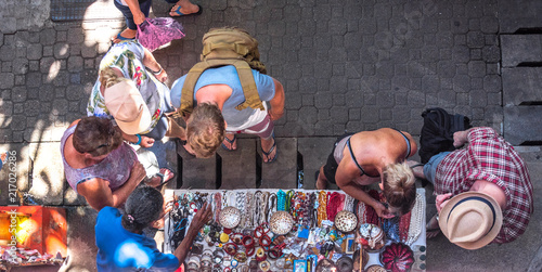 Obraz na płótnie Tourists shopping and looking at souvenirs