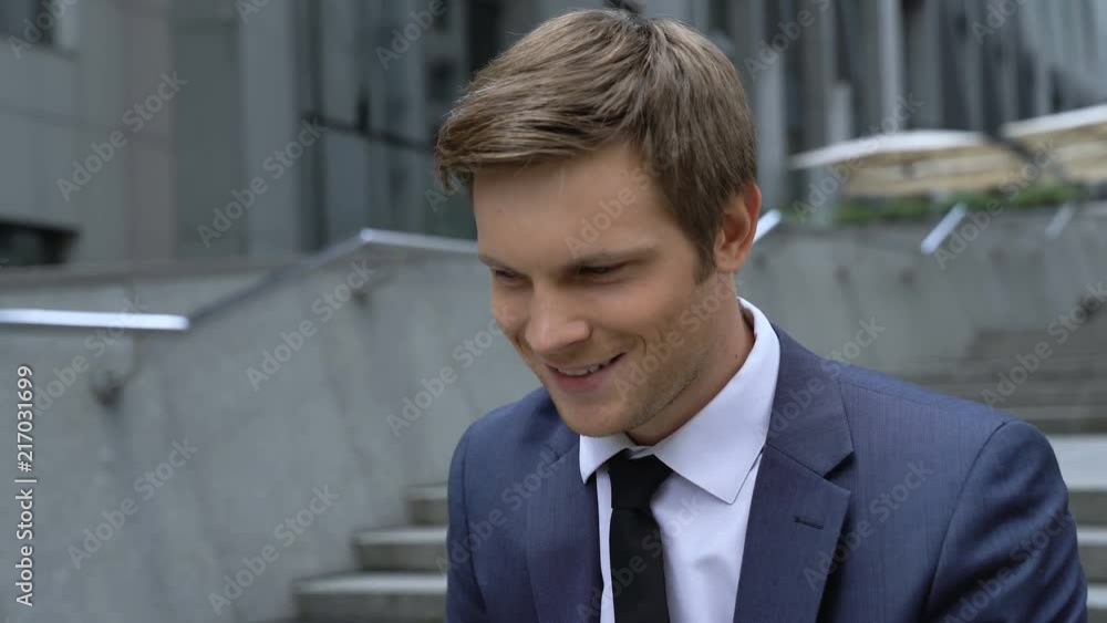 Businessman happy about successful startup, stairs as concept of personal growth Businessman happy about successful startup, stairs as concept of personal growth