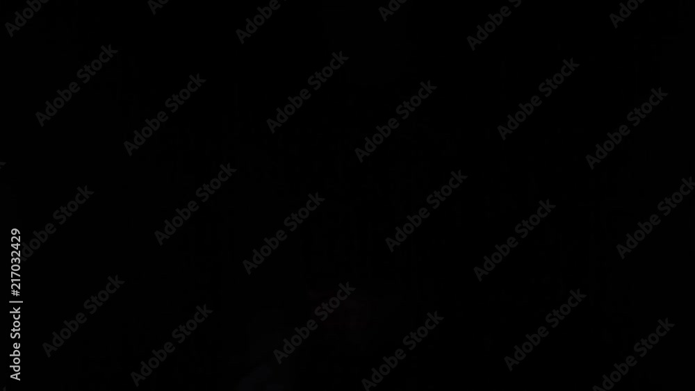 Hand Gestures coming out of the dark into the light. Holding GFX object vertically. Pointing stage right. Hand Gestures coming out of the dark into the light. Holding GFX object vertically. Pointing stage right.