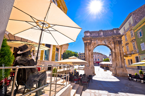 Street of Pula with historic Roman Golden gate and James Joyce statue view