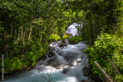 Fototapeta Naklejka Na Ścianę i Meble -  Geiranger - July 30, 2018: Little river stream in camping site in Geiranger, Norway
