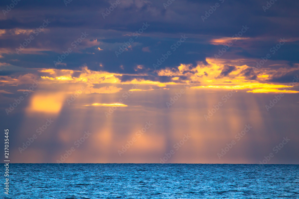 Sun rays from the clouds. Sun rays on the water. Evening at the sea. Calm. Sun rays from the clouds. Sun rays on the water. Evening at the sea. Calm.