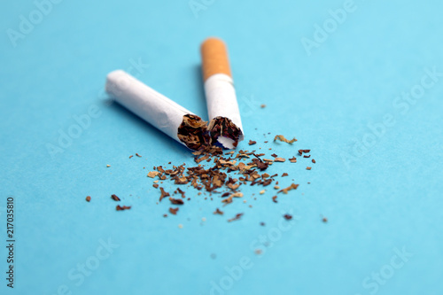 broken cigarette on a blue background
