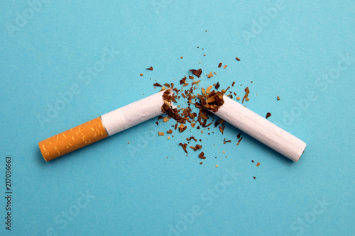 broken cigarette on a blue background photo
