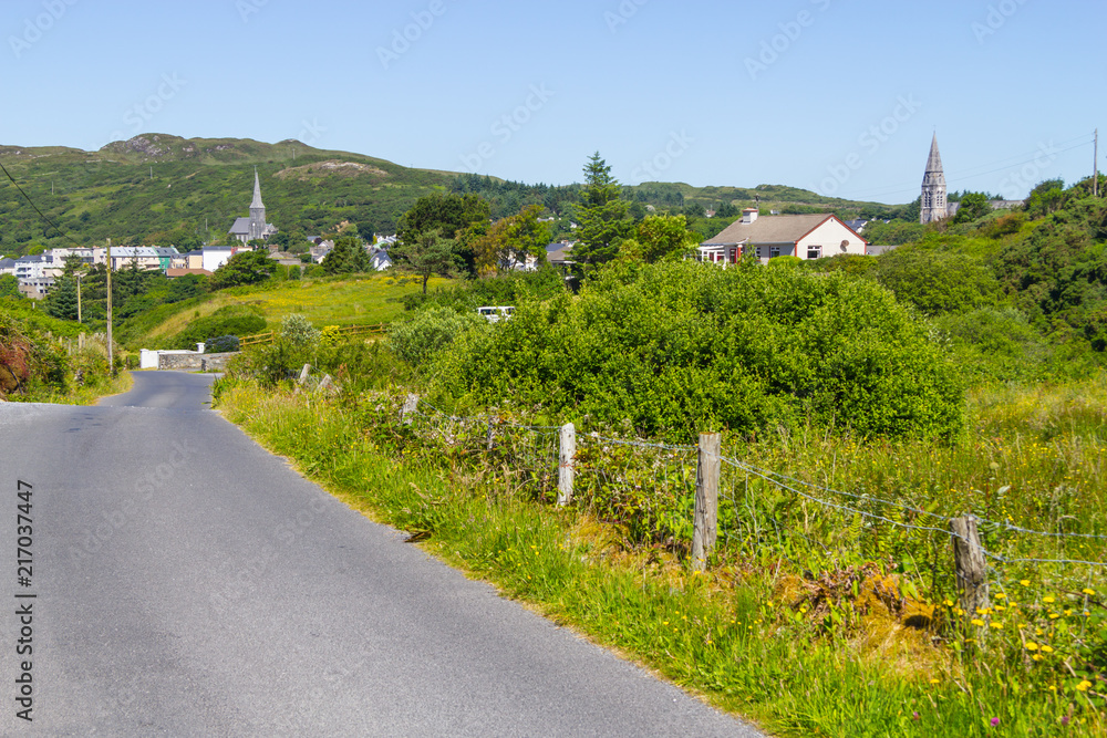 Church, city, mountains and vegetation in Clifden