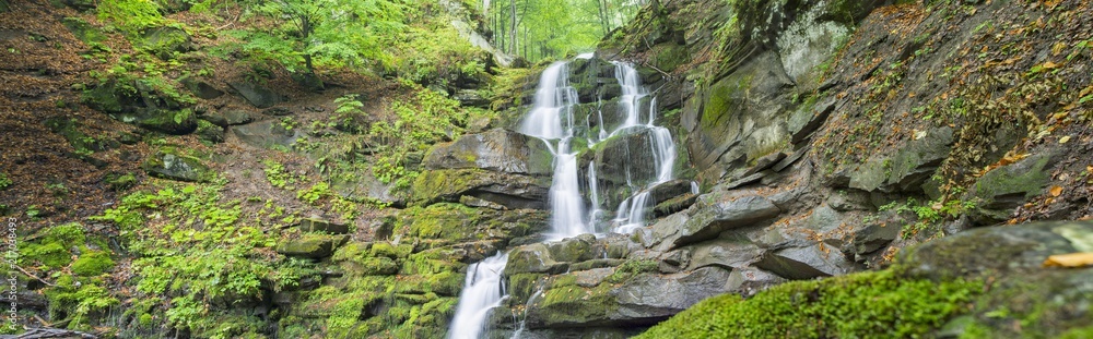 panoramic view to waterfall in canyon