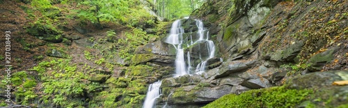 panoramic view to waterfall in canyon
