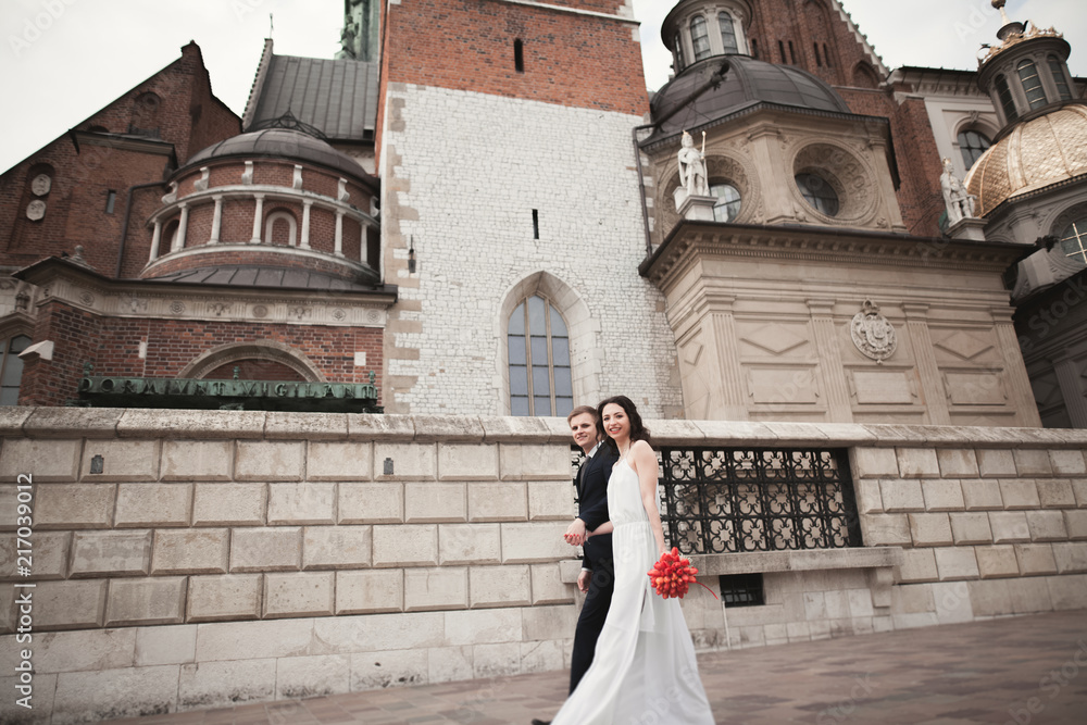 Wedding couple, bride and groom walking near a church in Krakow