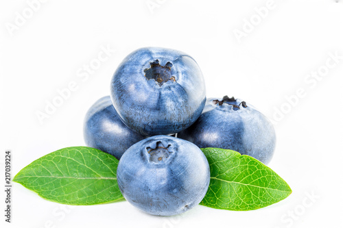 Isolated blueberry. Four fresh blueberries with leaves isolated on white background