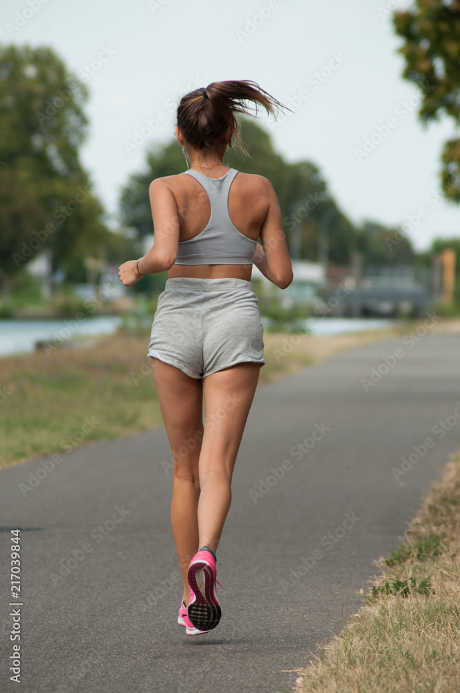portrait on back view of sexy girl running in border channel Stock Photo |  Adobe Stock