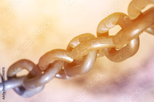 Old metal chain with sunlight, industrial background, strengh concept