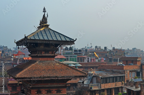 Buddhist pagoda on the background of the roofs of the city in Nepal