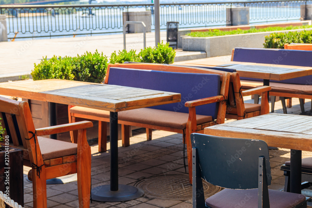 Chairs and tables in cozy outdoor cafe at summer