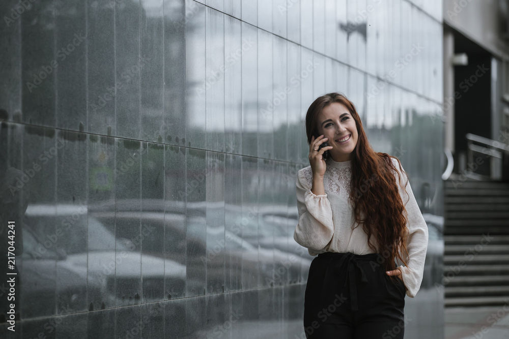 Portrait of a business woman talking on the phone in the city streets Portrait of a business woman talking on the phone in the city streets