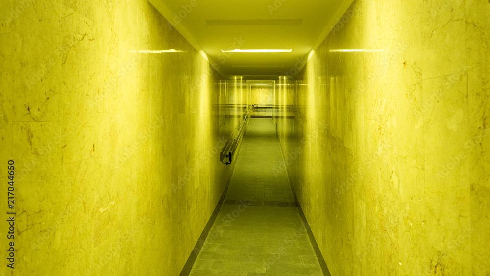 Tunnel, a long corridor at the end of which is light. Basement with illuminated walls. Neon