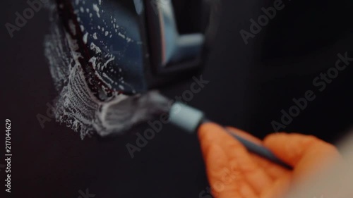 man does dry cleaning of the car