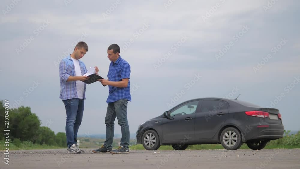 On the road car accident insurance agent examining carcrash owner and insurance staff make paper form lifestyle. two men make a deal. man seller driver makes car the auto insurance slow motion video On the road car accident insurance agent examining carcrash owner and insurance staff make paper form lifestyle. two men make a deal. man seller driver makes car the auto insurance slow motion video