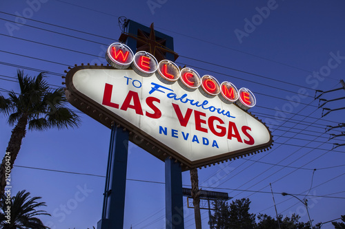 Welcome to Fabulous Las Vegas sign, palm trees and overhead wire grid at night. 