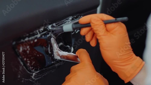 man does dry cleaning of the car