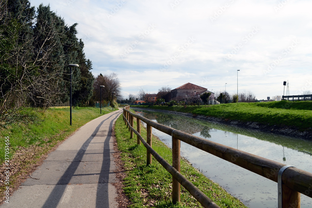 Nice green landscape of the wide country side of the Po valley in Italy here, near the little town of Rovigo a nice small river, the Adigetto and lots of green