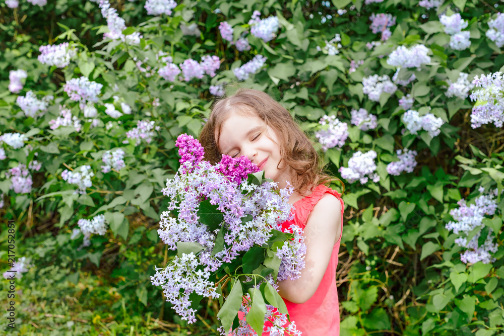 happy girl holding a bouquet of lilac. happy mother's Day! girl congratulates her mother, gives a bouquet of lilac flowers. happy girl holding a bouquet of lilac. happy mother's Day! girl congratulates her mother, gives a bouquet of lilac flowers.