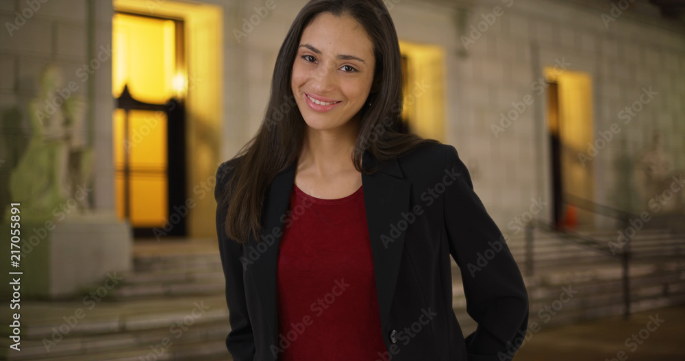 Smiling portrait of Latina businesswoman outdoors in evening