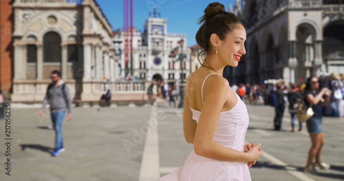 Smiling Latina tourist stands in St Marks square Venice Italy