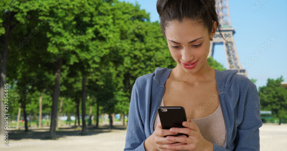 Beautiful Latin female using mobile phone near Eiffel Tower France Beautiful Latin female using mobile phone near Eiffel Tower France