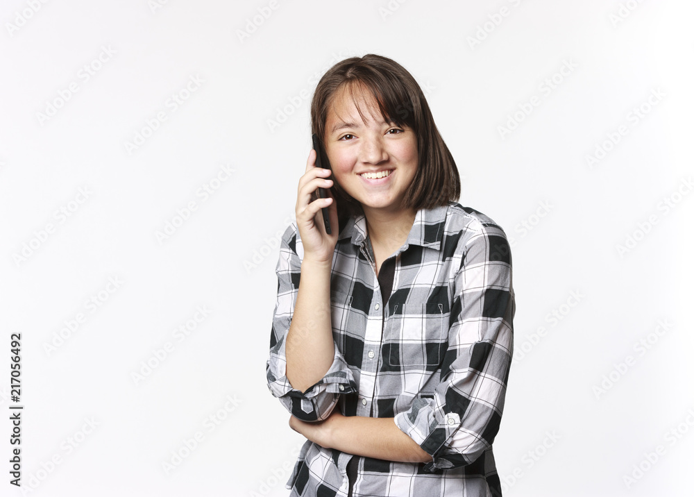 Happy teen girl talking on cell phone. Happy teen girl talking on cell phone.